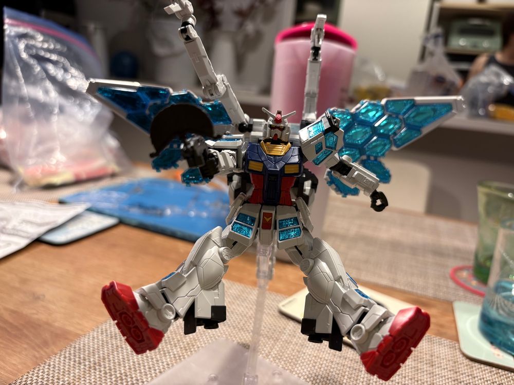 A photo of the same model in a different pose - legs splayed and gun pointing forward, as if flying backwards. 