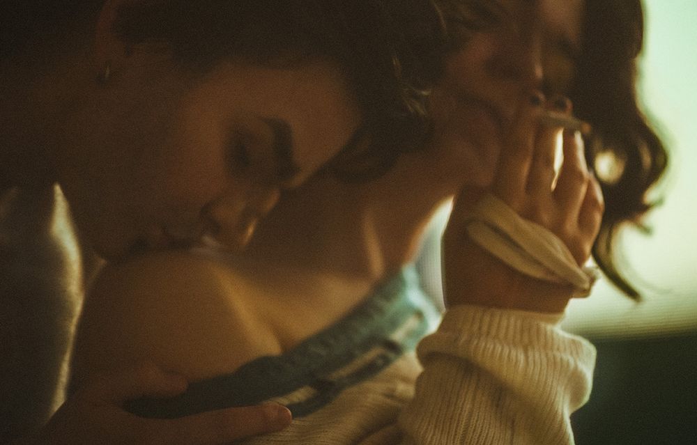 close up shot of vander who is now standing behind silco and kissing silco's exposed shoulder gently