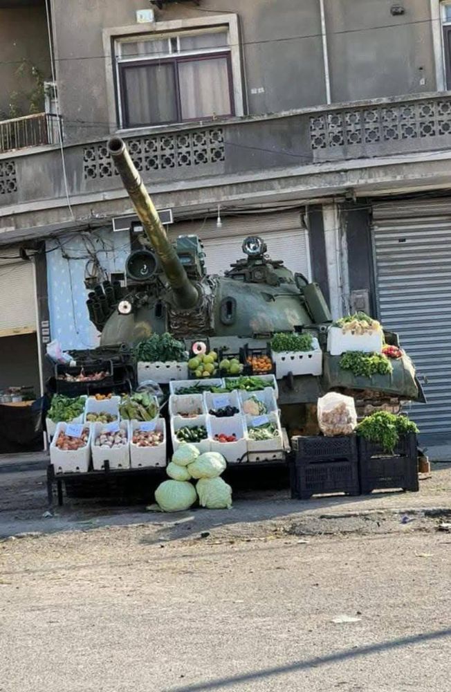 Tank with vegetables for sale piled on it