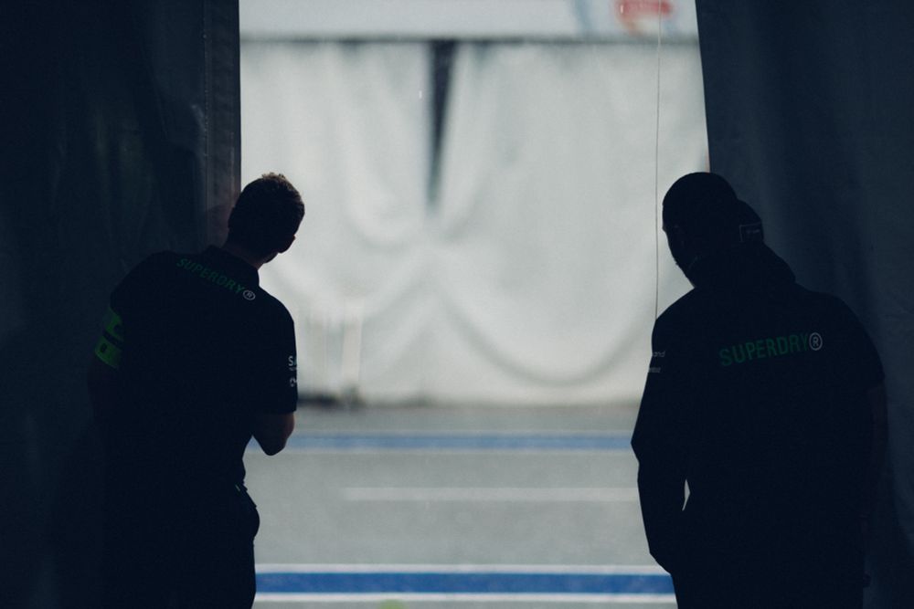 Engineers survey the heavy rainfall outside the garage.