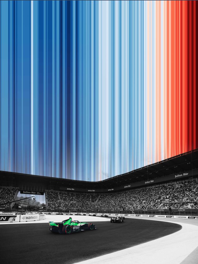 Climate Stripes, which highlight the progressive heating of our planet from blue to red, sit atop a muted photograph of the opening lap of the 2025 Mexico City ePrix. Racecars can be seen tackling the stadium section of the circuit, in front of a capacity crowd. The only hint of colour is the green Envision Racing Gen3 Evo of Sebastian Buemi in the foreground. 