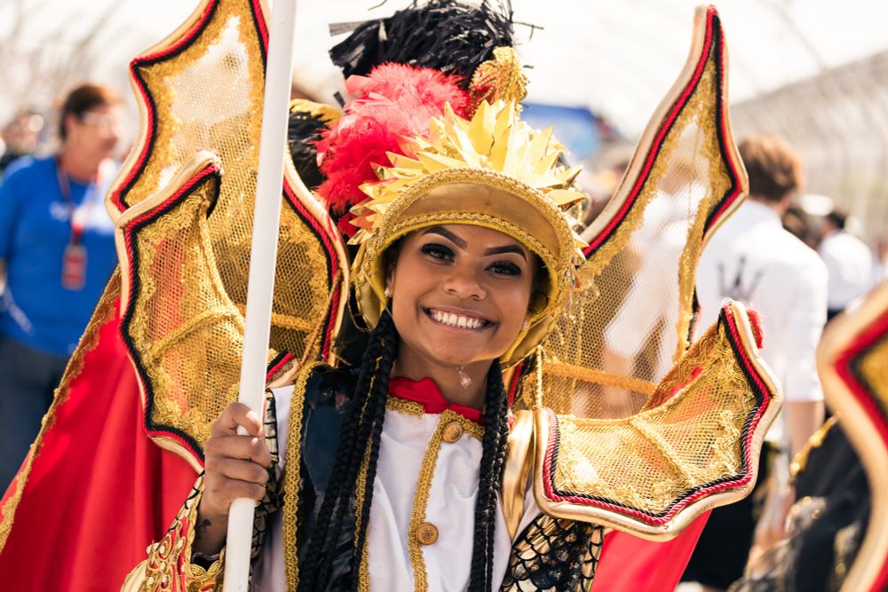 A person wearing traditional costume on the grid at the São Paulo ePrix in Season 10 of the FIA Formula E World Championship.