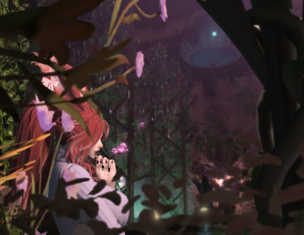 Lynnea Ymir (a redheaded and busty Veena woman) in a very plant-based surroundings, a room that she has turned into a sanctuary for the study of insects and vilekin, with many plants, dim lighting and lots of running water!

In this screenshot, Lynnea is partially obscured by the plant life. She is sitting and contemplating, with her hand held at her chin. Her red furred rabbit like ears can be seen to be heavily pierced and she has black painted nails, decorated with a small butterfly figurine. She is wearing an array of jewellery and she has make-up that accentuates her leporine nose and freckled cheeks. She is clearly busty, her chest large within her figure hugging sweater dress.