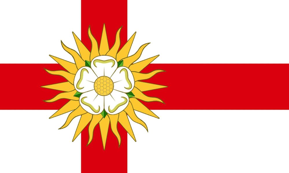 The official flag of the West Riding of Yorkshire, designed by Michael Faul.

The flag is white, with an offset red cross in Scandinavian style, reflecting the Anglo-Scandinavian history of the region during the era when the Ridings were first established. 

The cross is charged with a “rose-en-soleil” device was first used by Edward IV upon his accession to the throne, combining the five-petalled White Rose of the House of York with the Sun emblem (with alternate straight & wavy rays) used by his royal predecessor, Richard II.