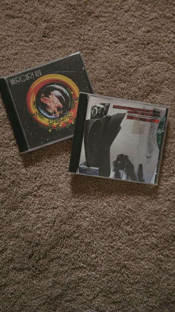 Two CDs: transmissions from the satellite heart by flaming lips and see you on the other side by mercury rev
