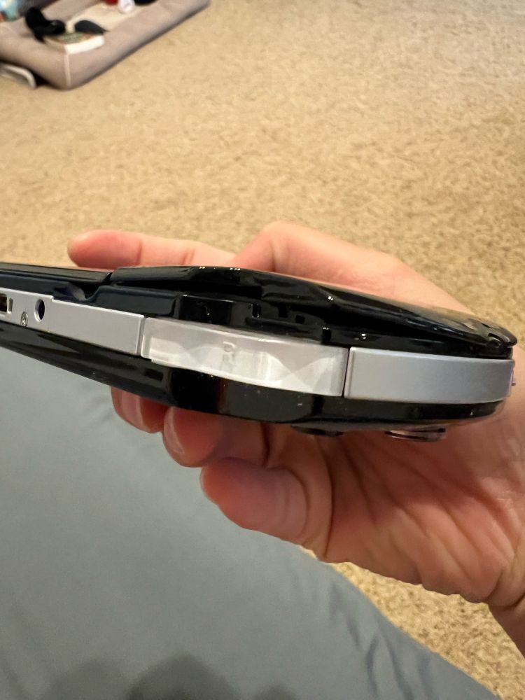 Side view of a PSP showing the swelling of its battery.