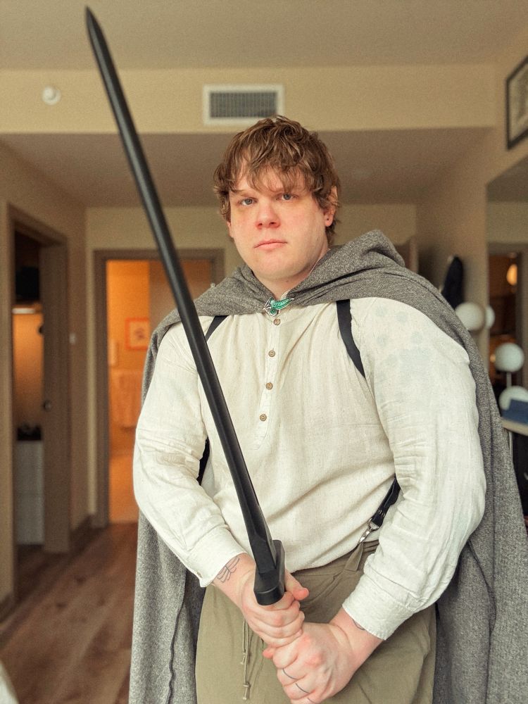 Me dressed up as Samwise Gamgee from The Lord of the Rings. I’m holding a black plasticine sword and have a stern look on my face.