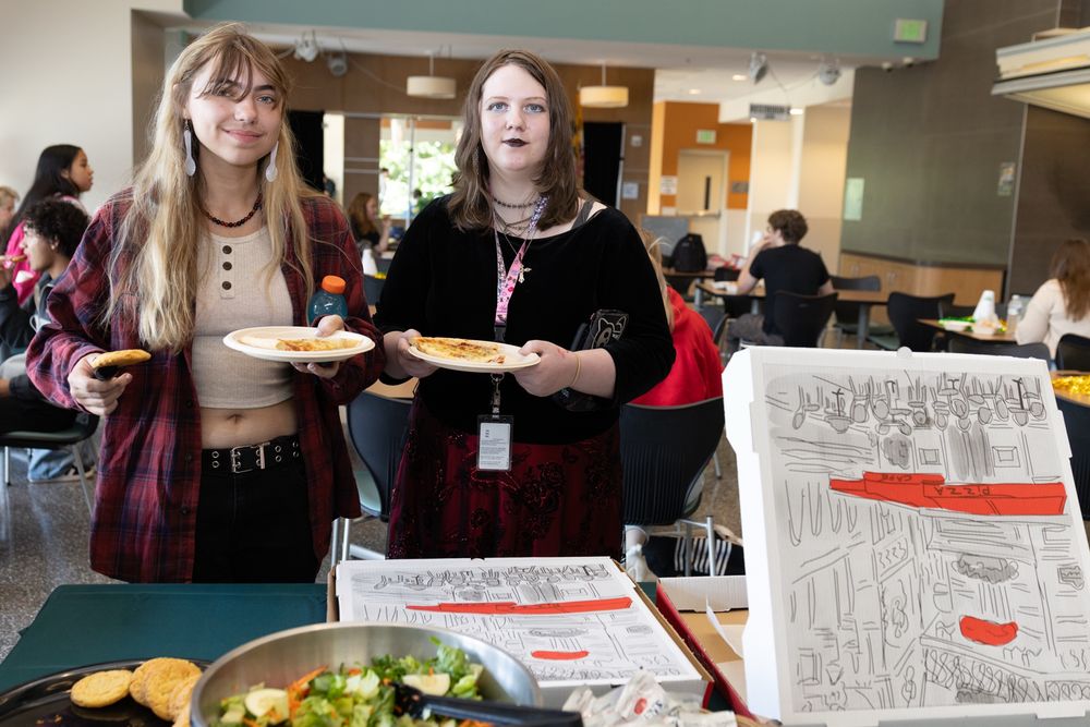 Two students in line for pizza