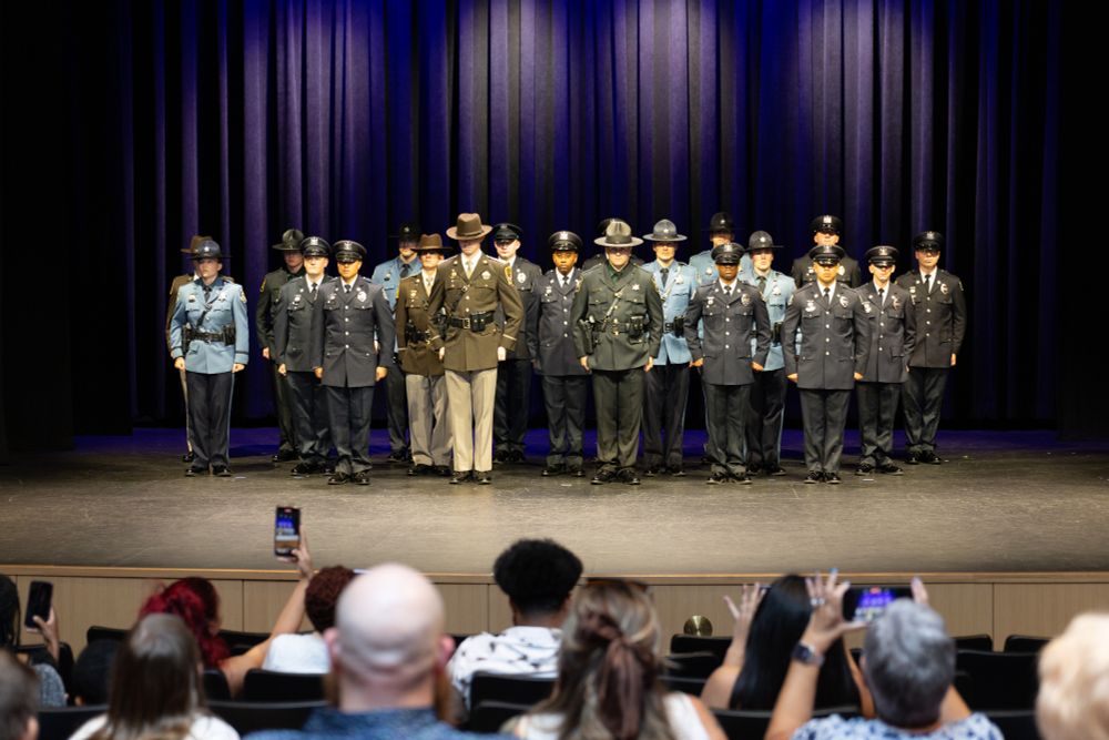 police academy graduates in group on stage