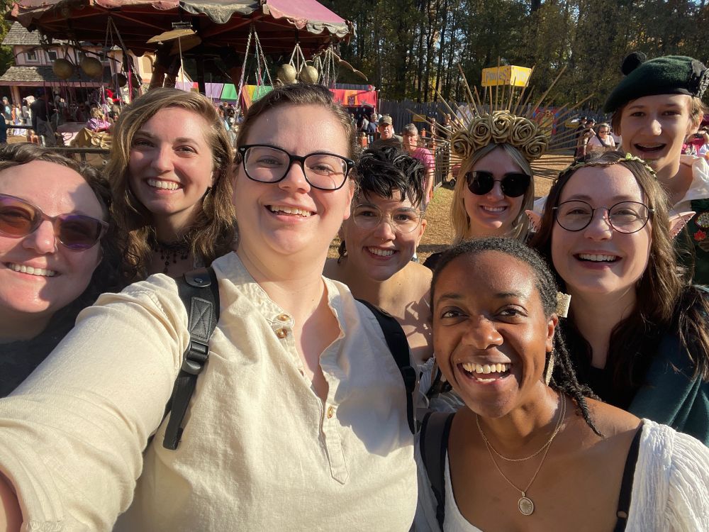 Some beautiful happy people in rennaisanxe costumes.