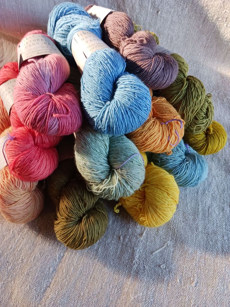 Multicolored skeins of naturally dyed wool singles.