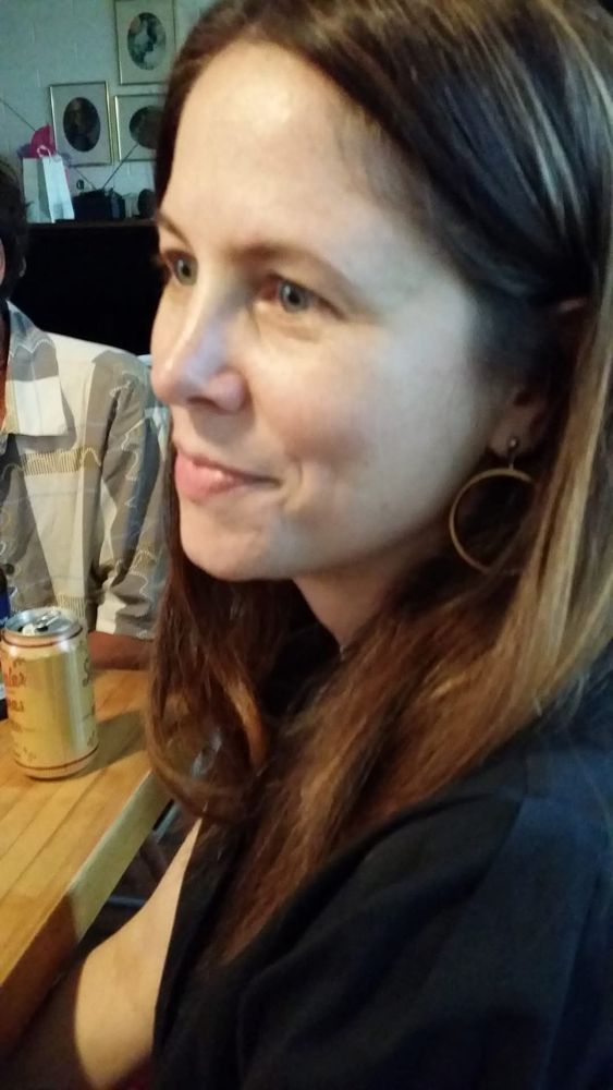 A photo of me from 10ish years ago, tableside with a can of beer
