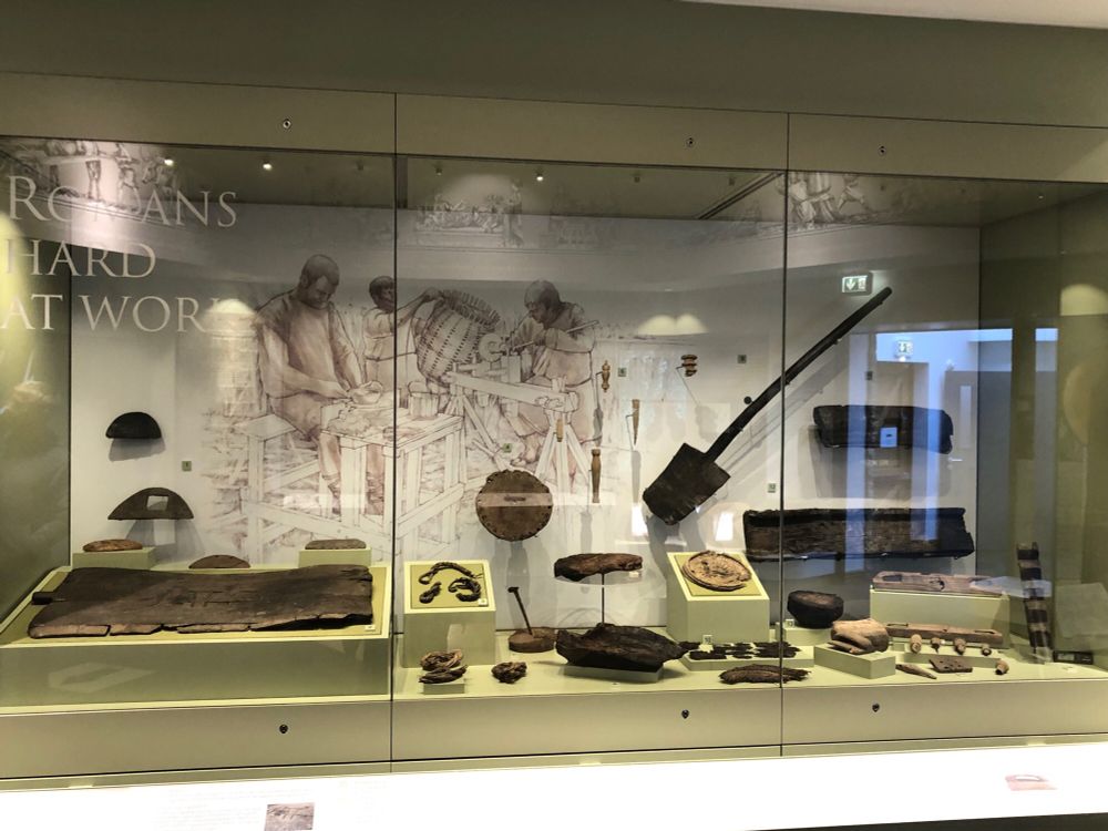 A large display case with over 20 different wooden artefacts excavated from Vindolanda including most obviously a wooden spade made from a single piece of wood. Photo copyright Coralie Mills 2024