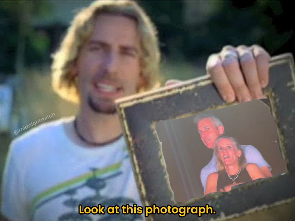 Lead singer of nickleback holding a photograph of two married people openly having an affair at a coldplay concert.  The words on the photo say "look at this photograph" like the nickleback song everyone knows but pretends to hate