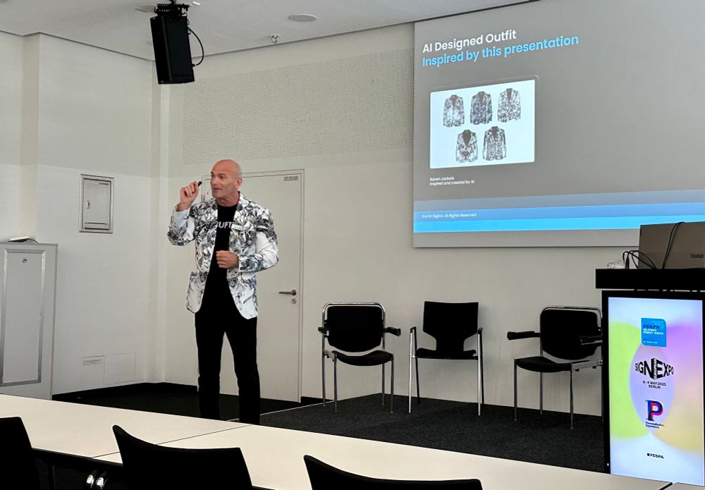 Ronen Samuel wearing a white jacket printed with an intricate black illustration.