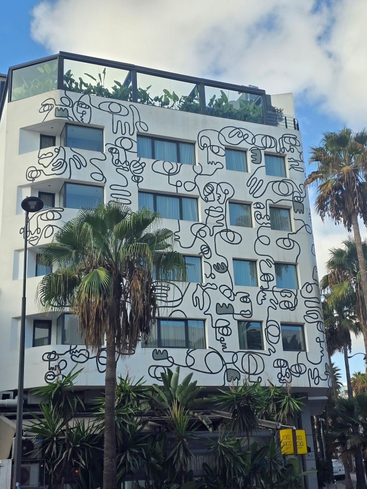 A modern concrete building decorated in impressionist artwork