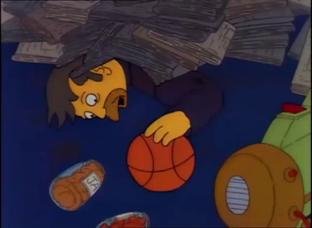 a cartoon of a man holding a basketball with a jar of peanuts on the ground