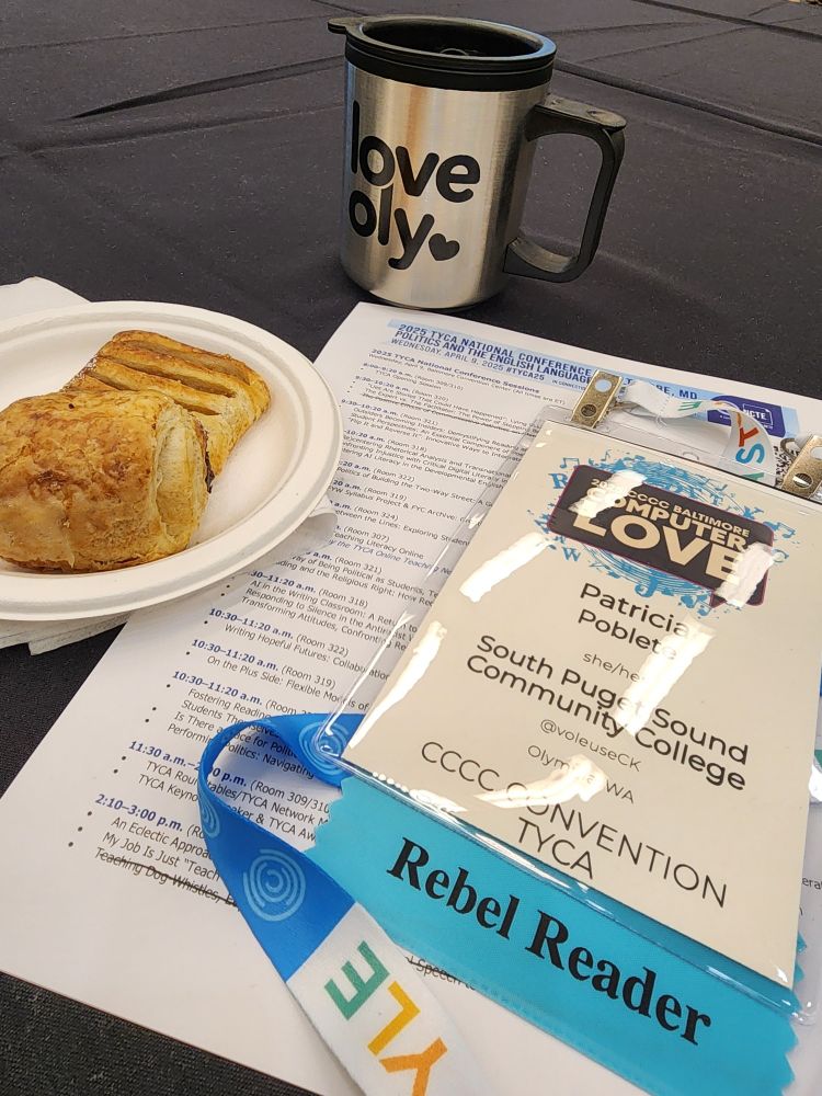 A picture of a travel coffee mug, two little pastries, a program listing for #TYCA25, and a conference badge attached to a lanyard.