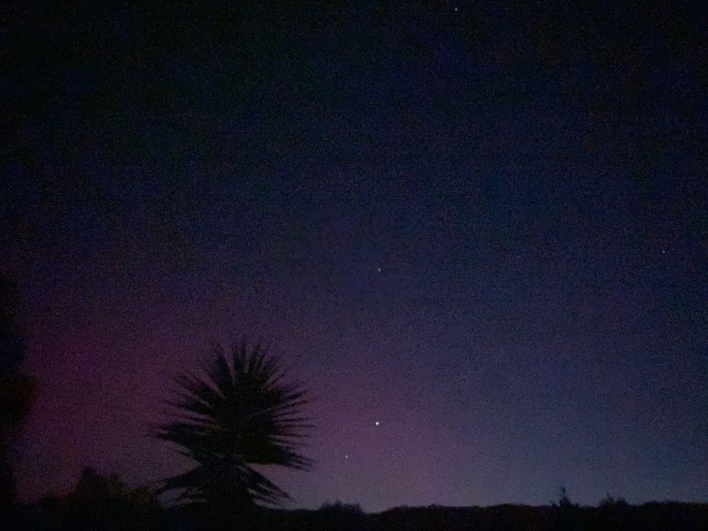 A blurry night photo capturing indigo and magenta tones of aurora Australis © 2025 Tracey L. Baglin  
