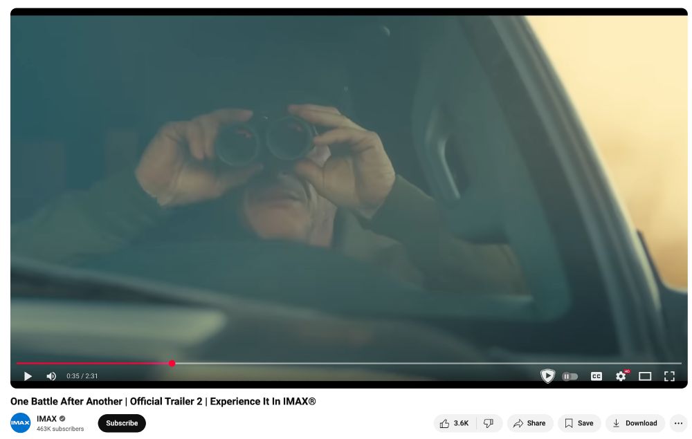 A screenshot of the YouTube page for the trailer of One Battle After Another, paused on a frame where Sean Penn looks through binoculars.