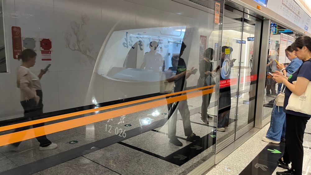 front of a beijing subway line 12 train viewed from behind full height platform screen doors