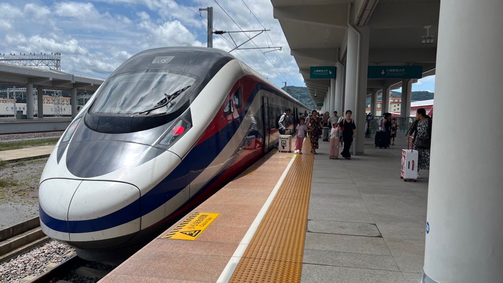 view down a platform of the back of a modern cr200j "high speed" train