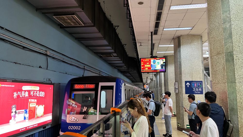 front of a beijing subway line 2 train viewed from the platform at an underground subway station 