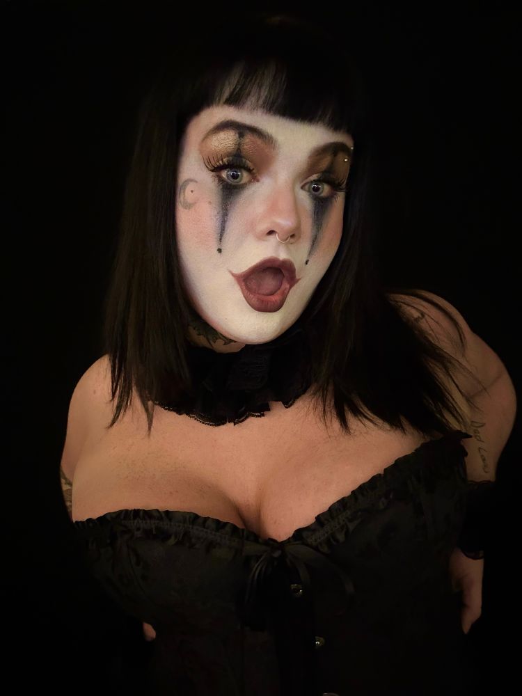 creepy is cosplaying in clown makeup and wearing a black corset! 