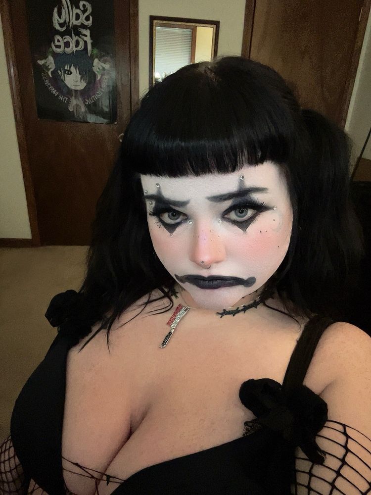 creepy in sad clown makeup with hair in pigtails