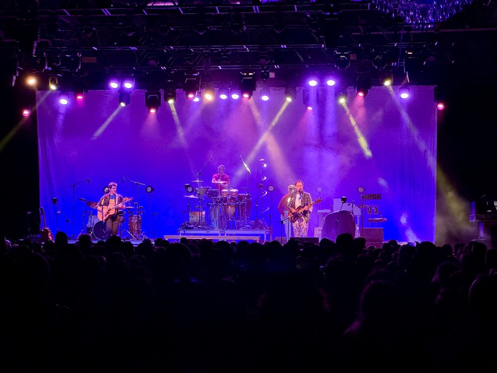 Band Guster playing on stage.