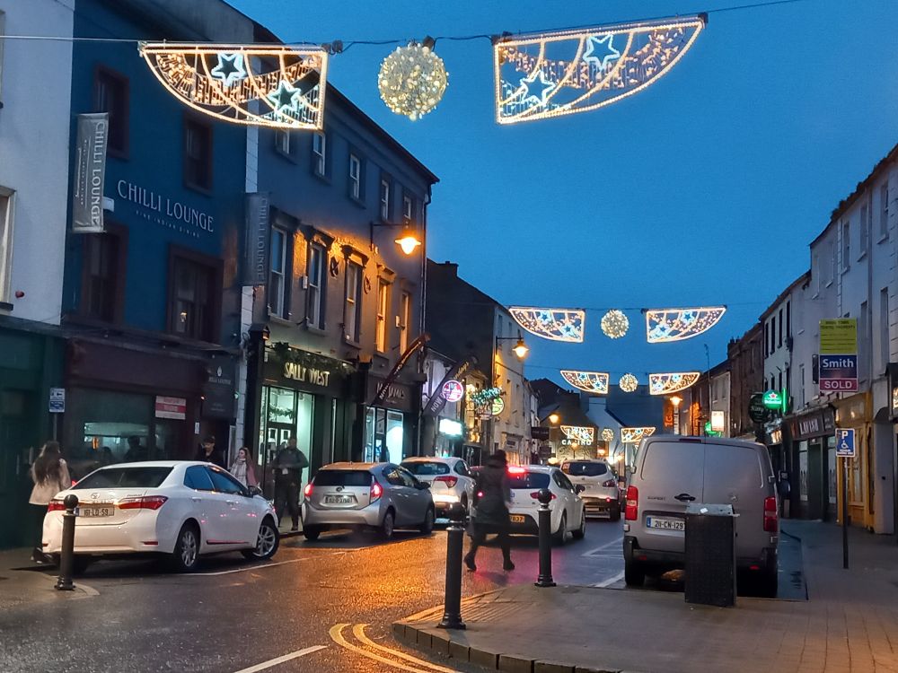 Christmas lights strung across a busy street