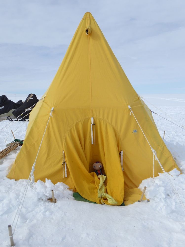 a yellow pyramid tent with e.t. the extra terrestrial in it