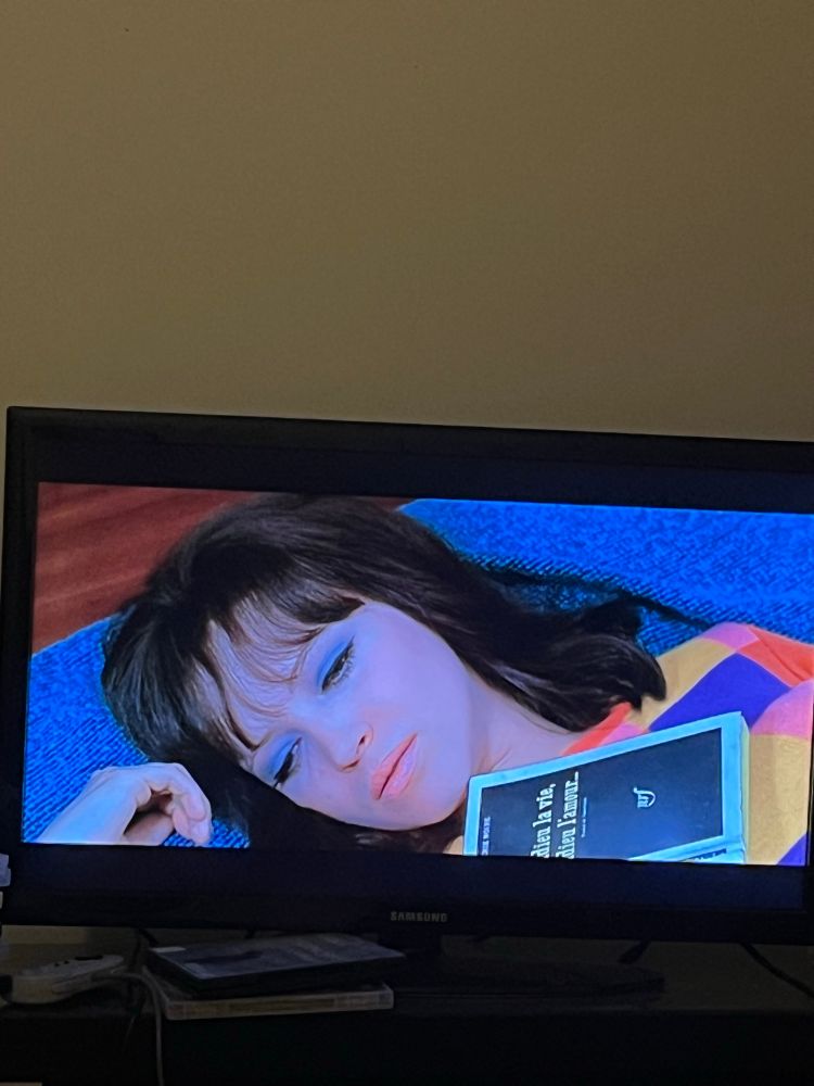 Anna Karina in Godard’s made in USA lounging a colour blocked knit shirt and blue eyeshadow