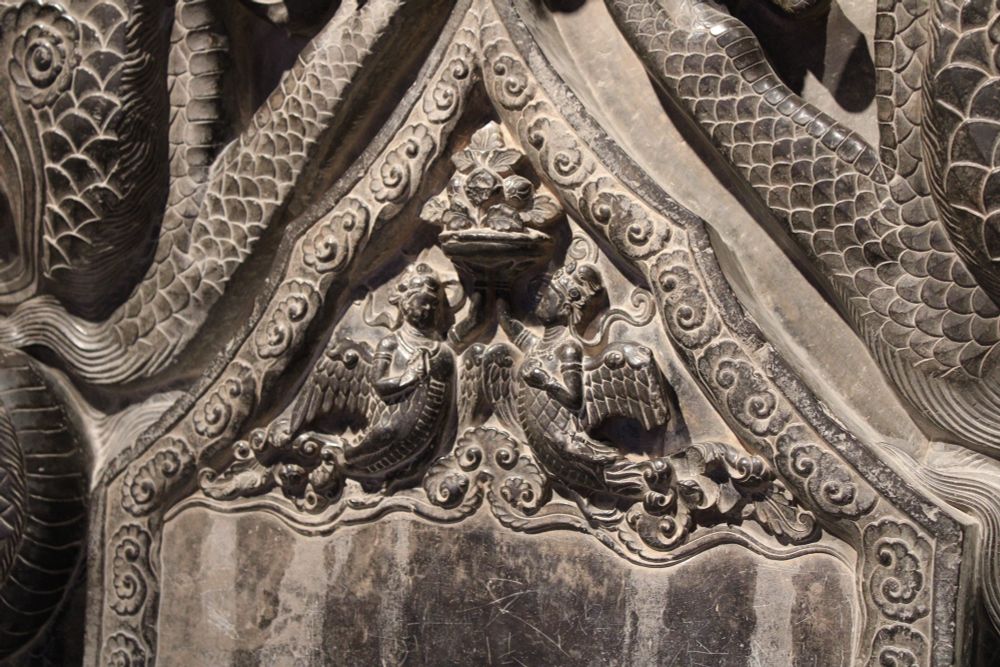 A detail of kalavinkas, birdlike creatures with human heads and arms, from a Tang stele topper, probably eighth century.