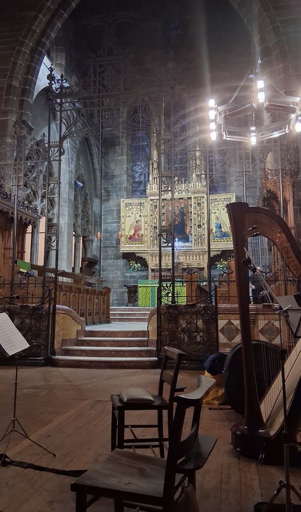 Candlelit interior of a grand old church, set up for a small classical ensemble