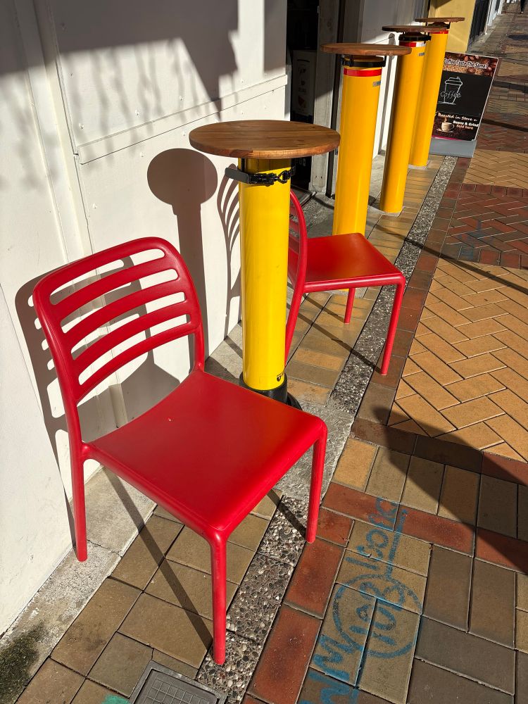 Bollards protecting a shop, with seats