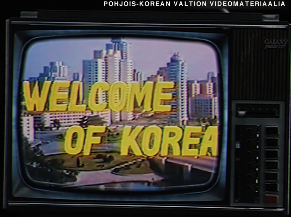 capture of that same documentary. NK soviet visuals, a film with a title "welcome of korea" with a picture of a futuristic city on background