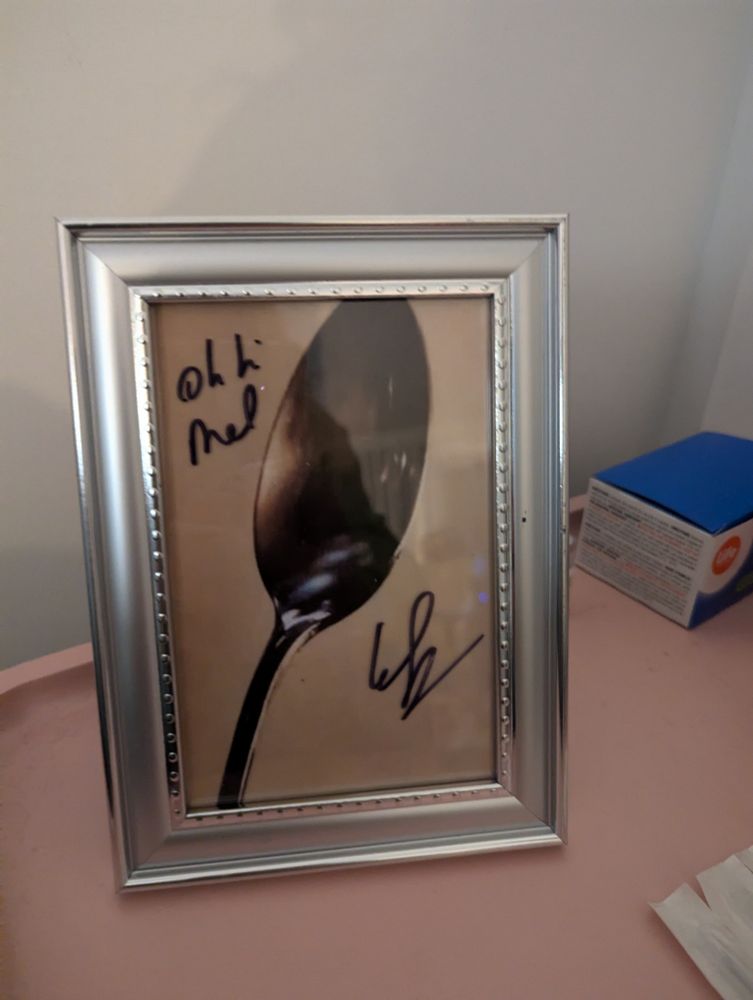 picture of framed spoon that is signed by Greg sestero