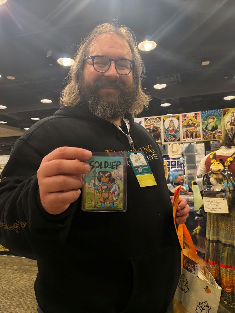 An absolute sovereign holding up a ln original soldier token