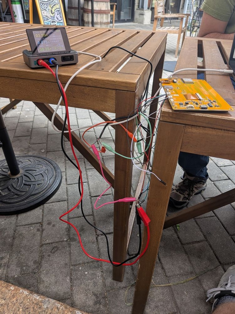 10ish wires of all different types and colors dangling between a cheap yellow display esp32 dev board, my laptop, and a little benchtop powersupply
