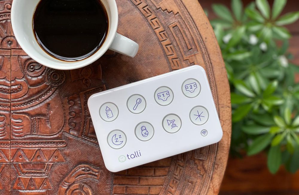 Talli brand baby event tracker. It has 8 buttons with icons, including a bottle, diapers with numbers 1 & 2, sleep, breastfeeding, etc.