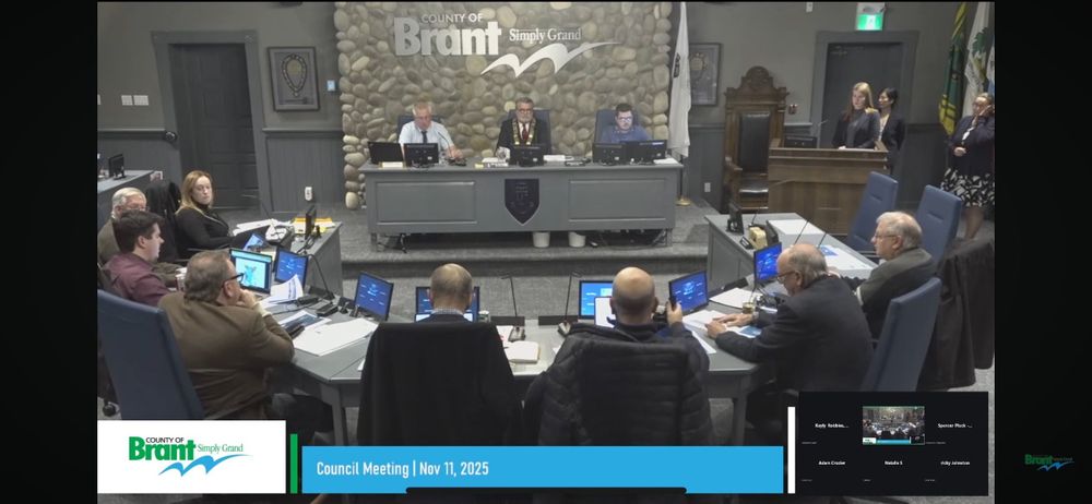 Brant County Council seated in the council chamber during a meeting, with staff and attendees listening to the presentation.