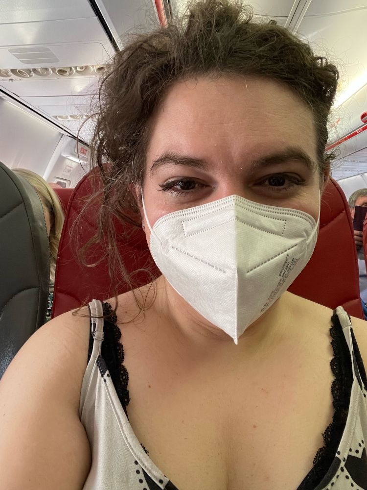 Me on a plane, masked 