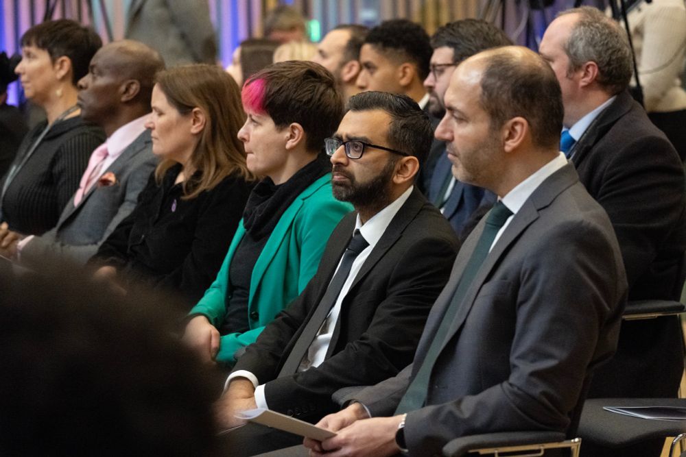 London Assembly members listening to speech.