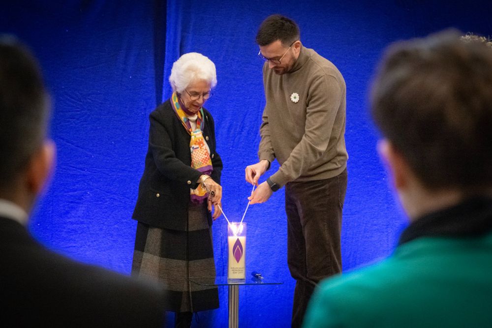 Man and woman lighting sticks from a candle