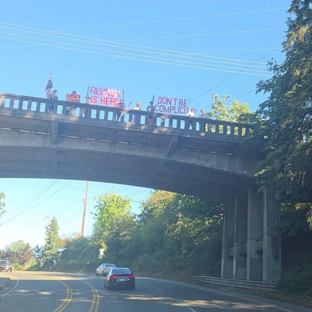 Folks on the Mitchel Ave overpass in Port Orchard, WA with signs that say 