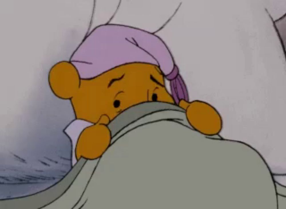 a cartoon of winnie the pooh wearing a night cap