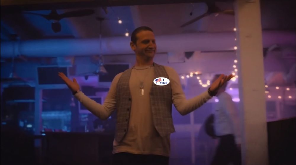 Tim Robinson in the sloppy steaks sketch, with an “I voted sticker” on