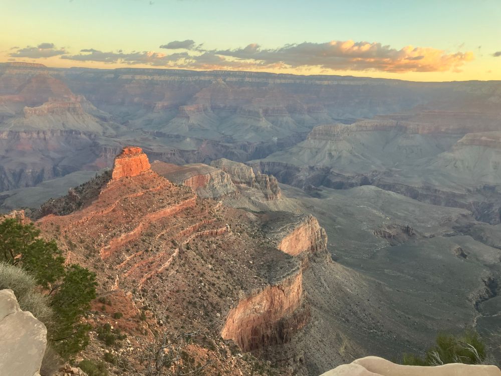 Looking down into the Grand Canyon before sunrise. The colors are muted yet deep, browns, reds, purples, blues, grays. 