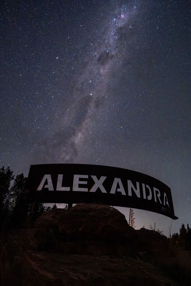 Milky Way behind a big metal sign with cut out ALEXANDRA